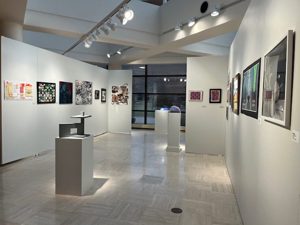 back section of the student show with various works of art